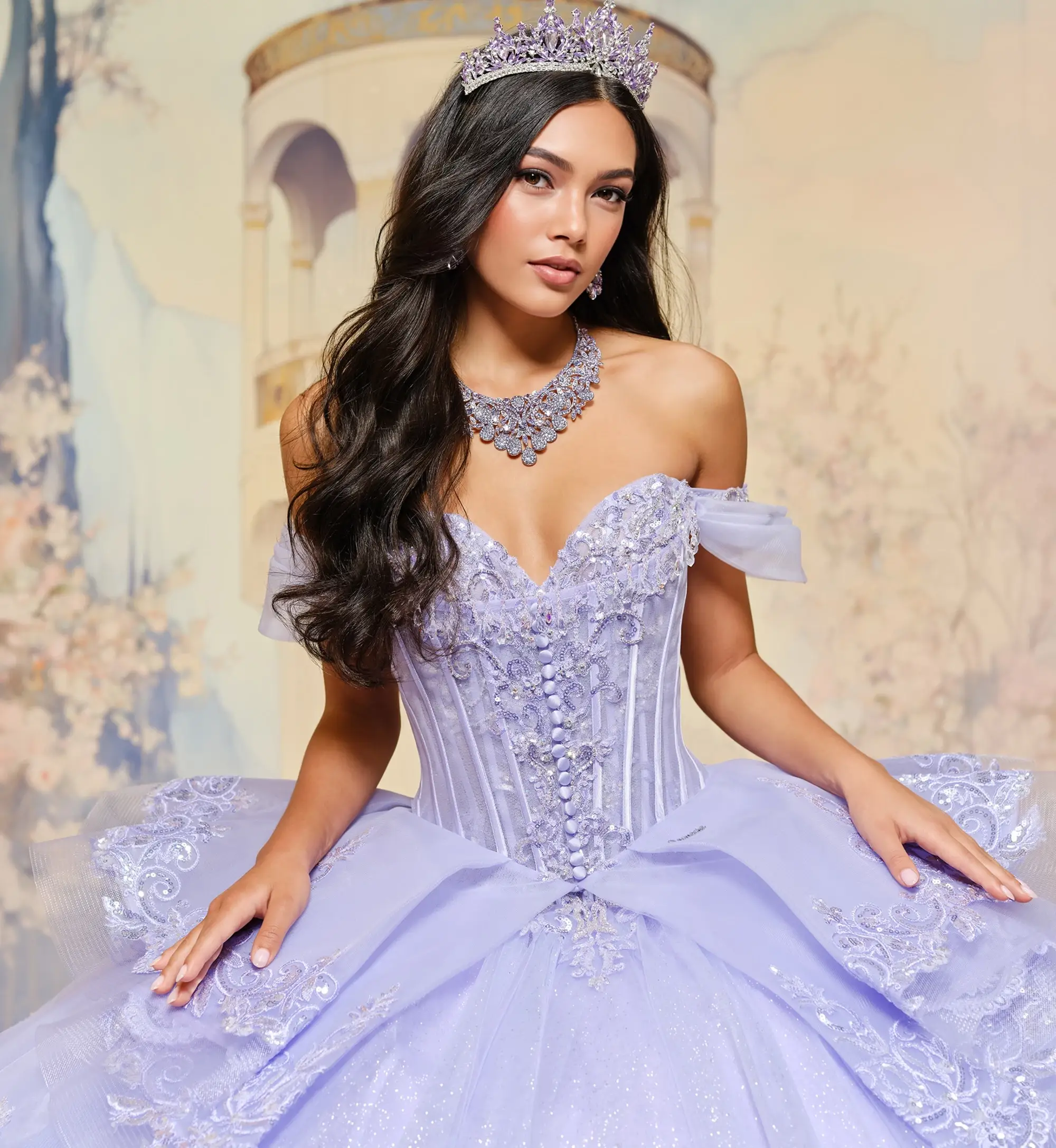 model is wearing a purple quinceanera dress
