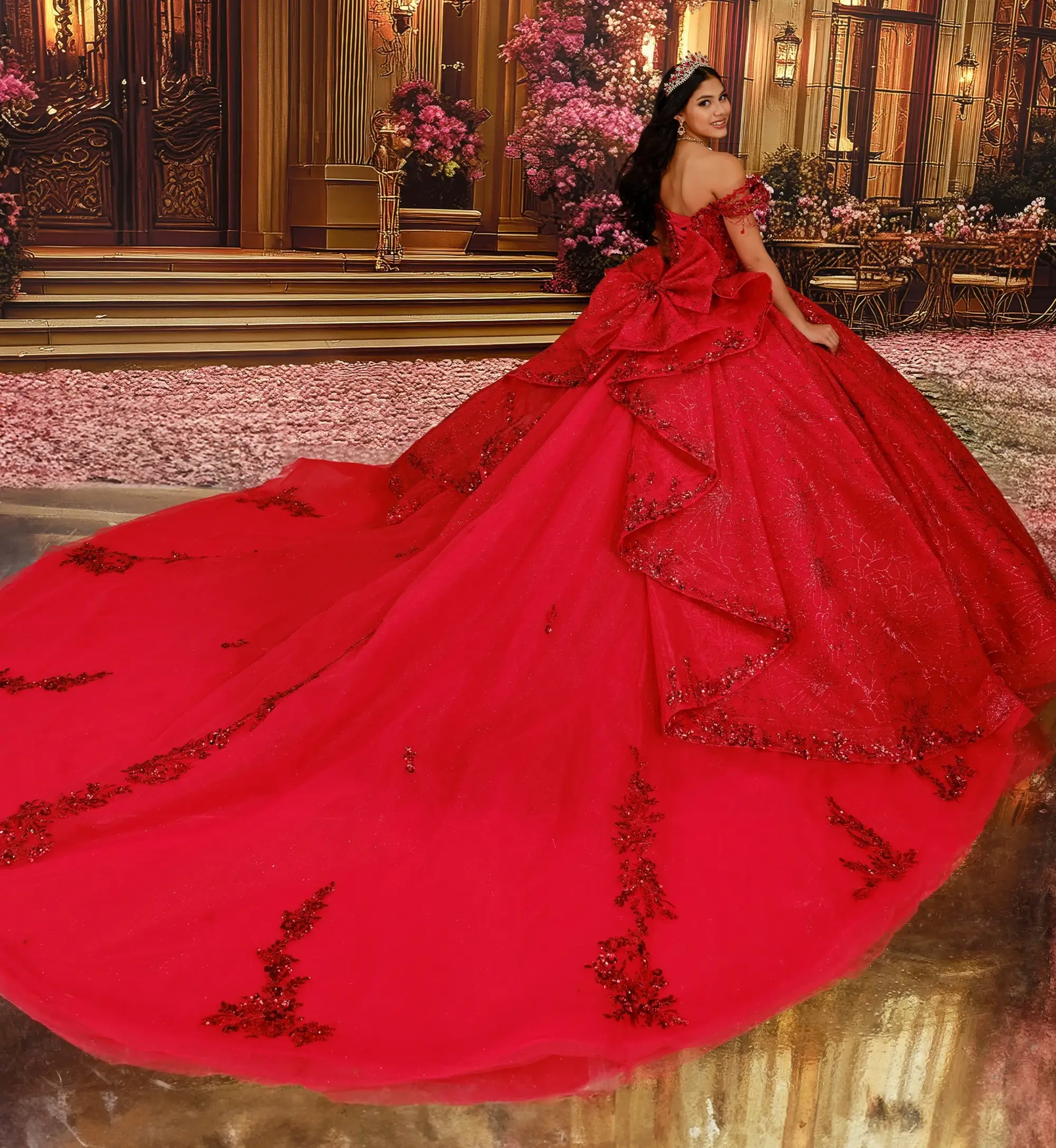 A person wearing an elaborate red gown with a long, flowing train, standing in front of a beautifully decorated room with floral arrangements and classic architecture.