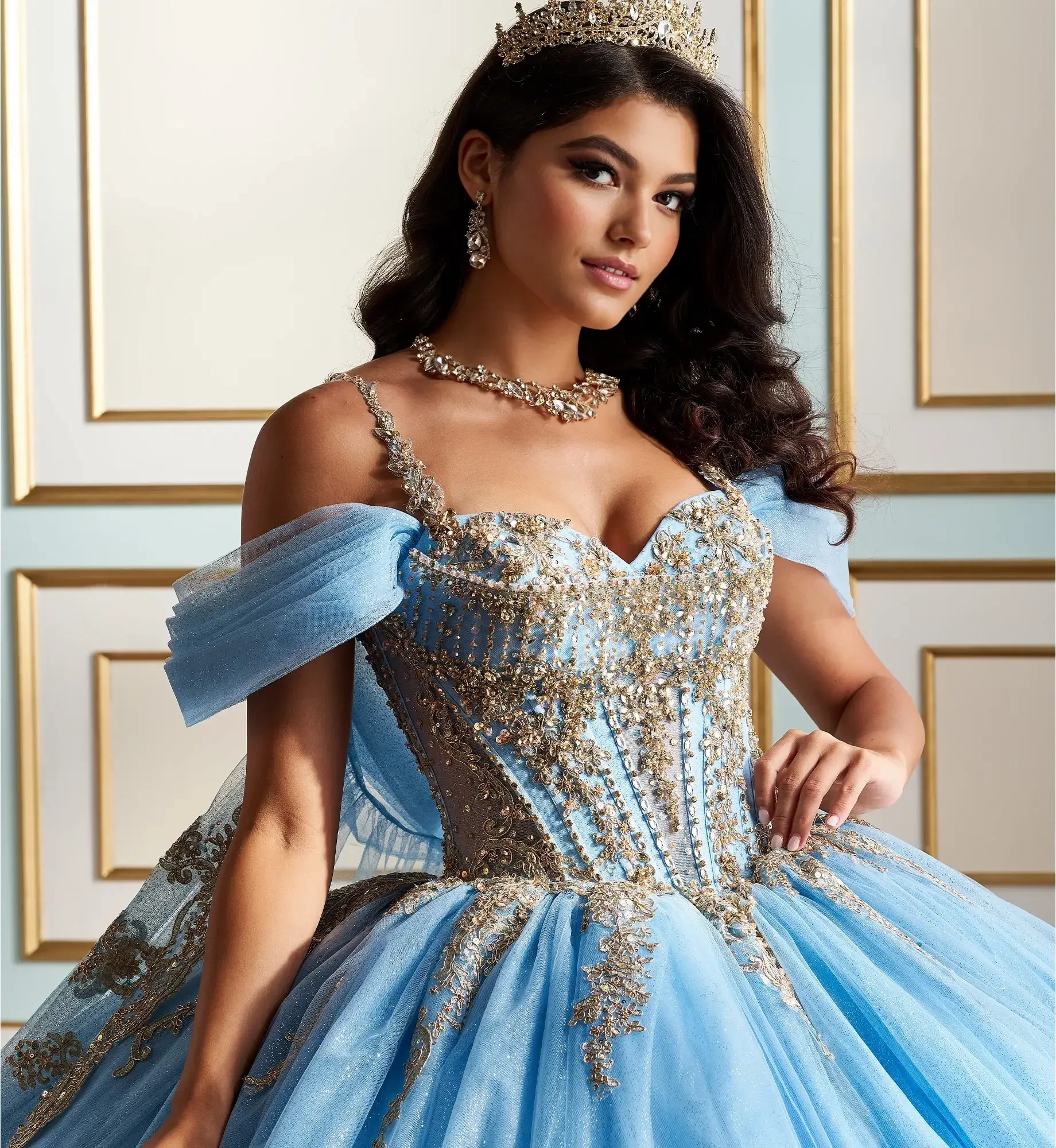 model is wearing an off the shoulder sky blue and gold quince dress