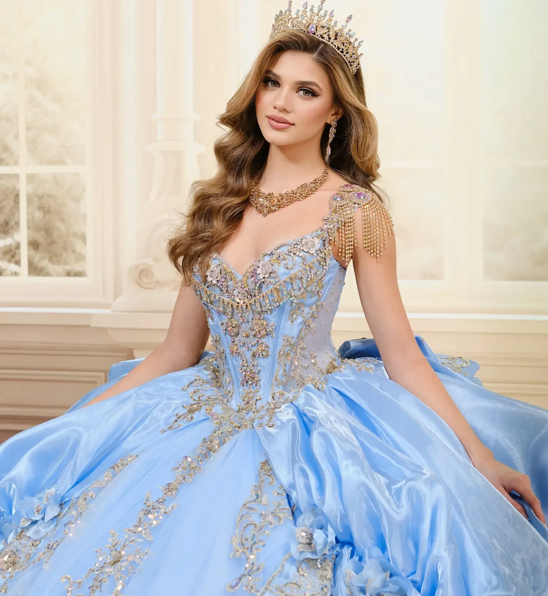 model is wearing a light blue and gold quinceanera dress