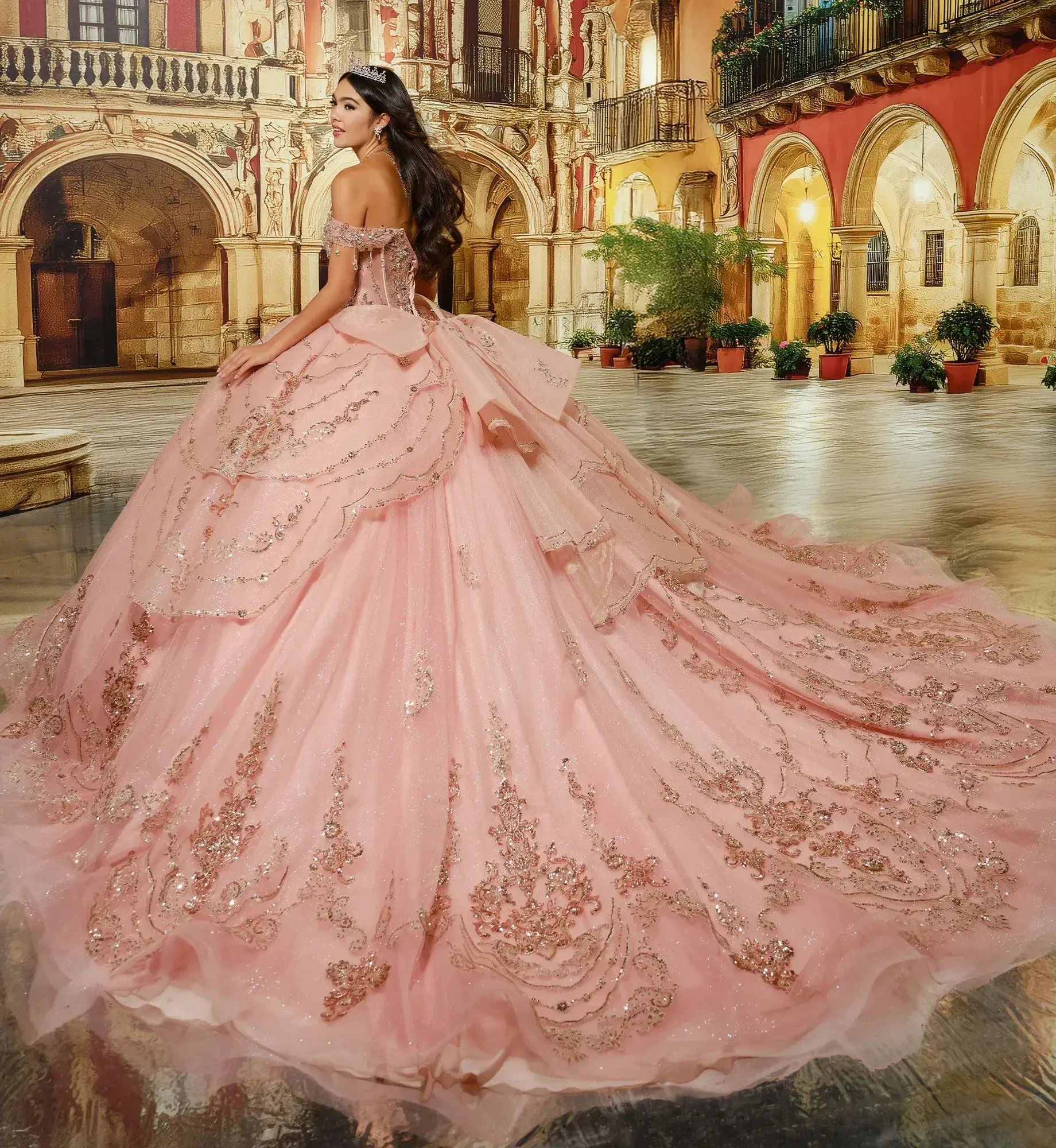 A woman in a lavish, pink ball gown with intricate embellishments stands in an ornate courtyard. The elegant scene conveys romance and grandeur.