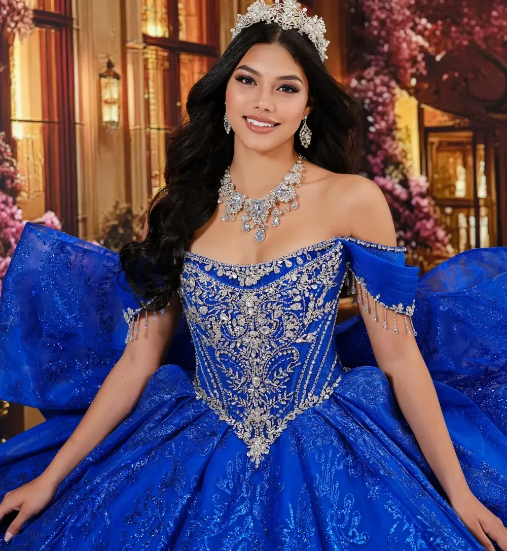 model is wearing an off the shoulder royal blue quince dress
