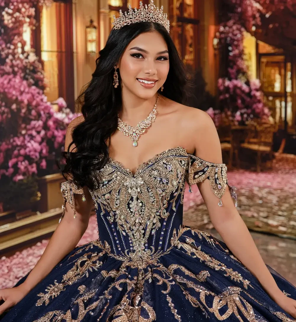 model is wearing an off the shoulder navy blue quinceanera gown