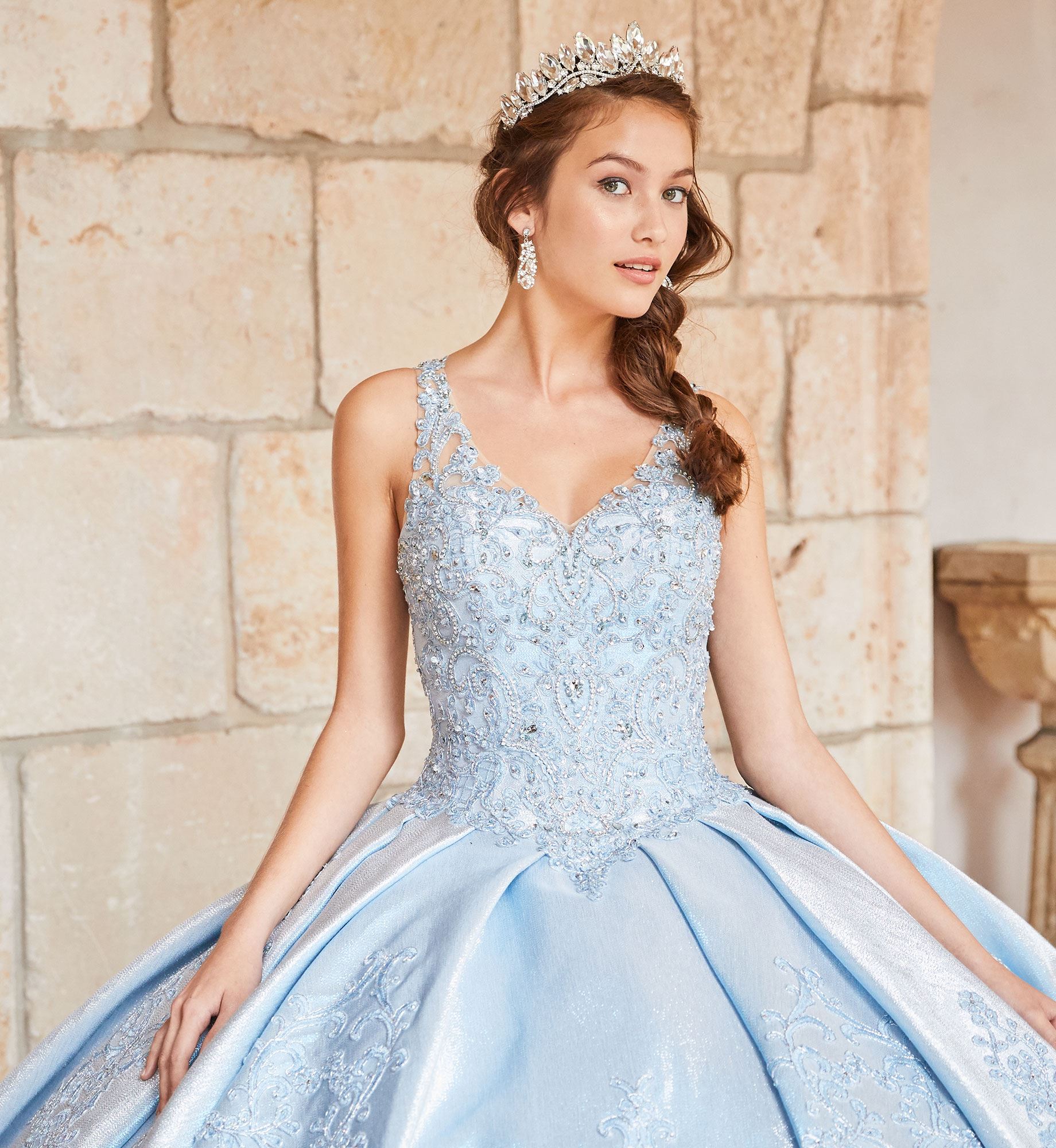 Close up image of brunette model in blue quinceañera dress