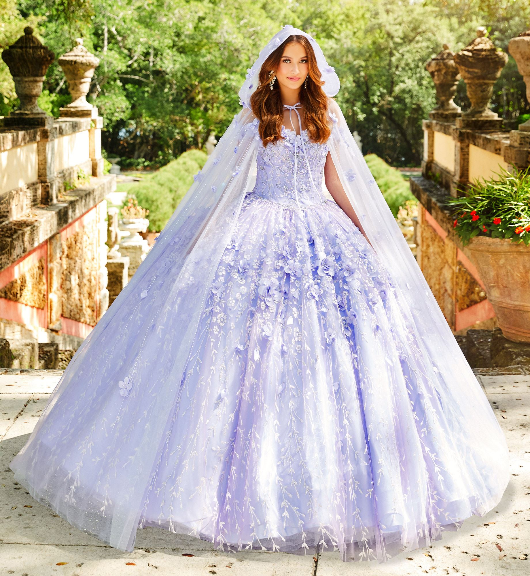 Brunette model in purple quinceañera dress with floral cape