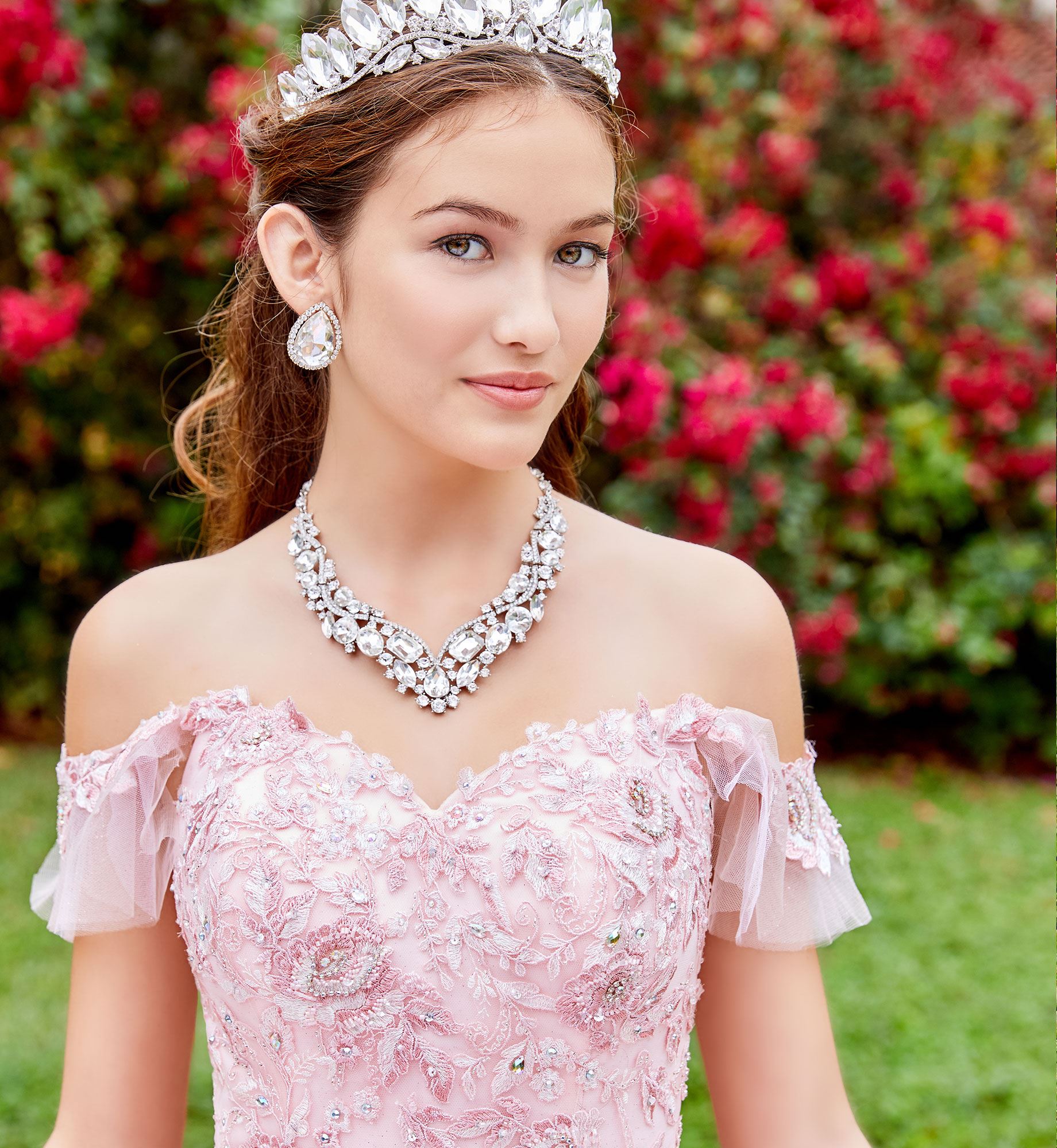 Close up of brunette model in pink off the shoulder quinceañera dress