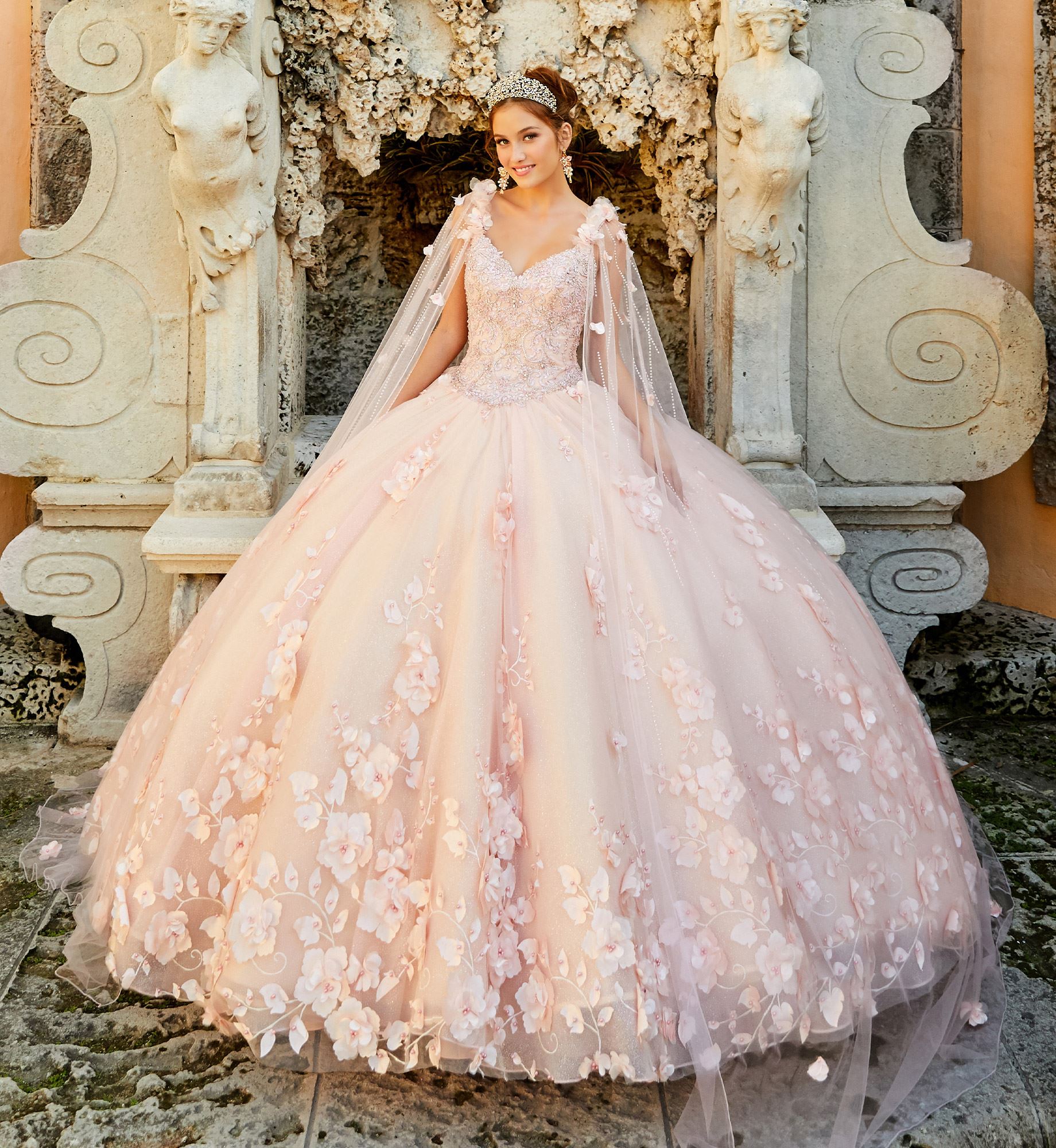 Brunette model in pink floral quinceañera dress