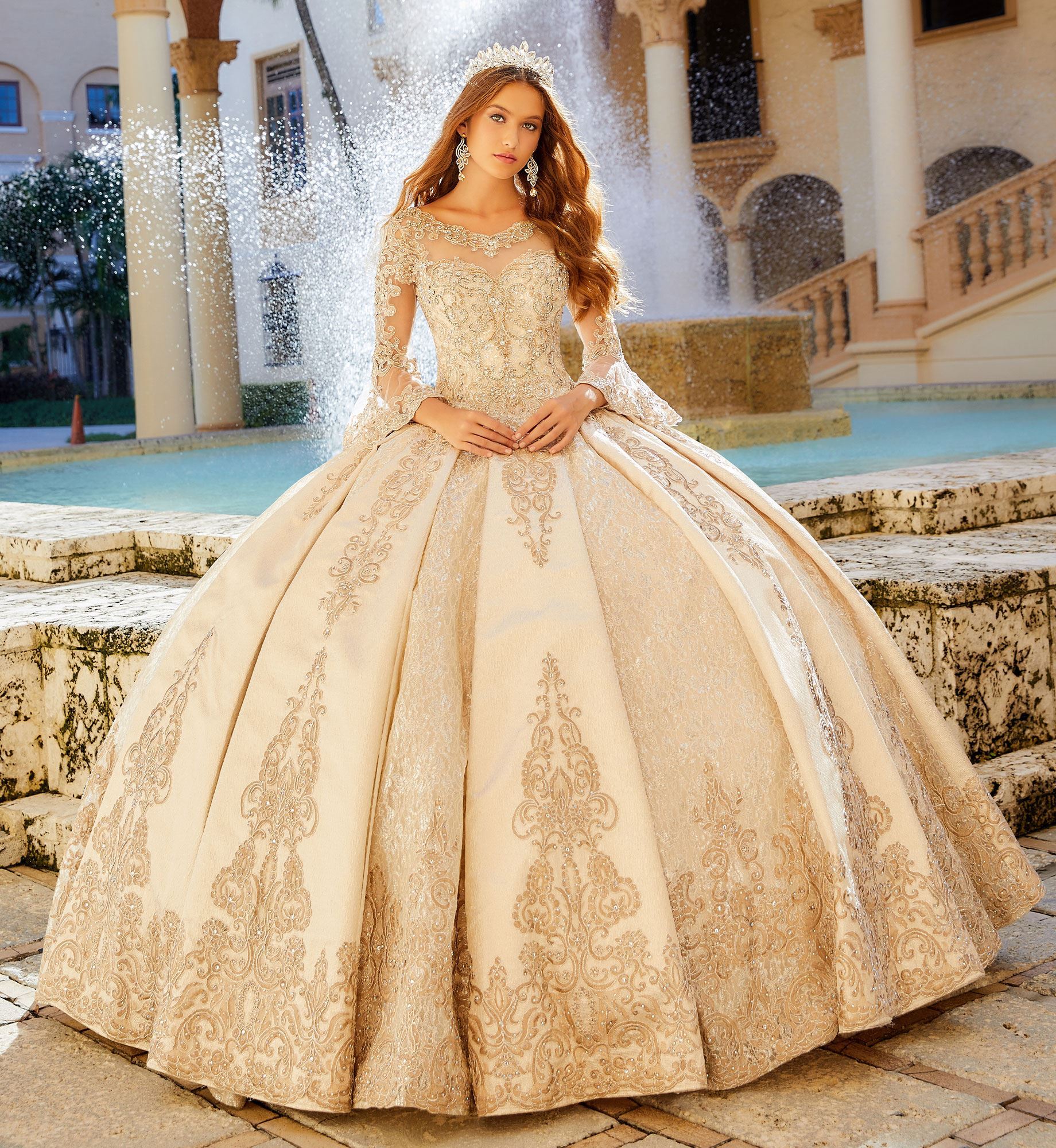 Brunette model in long sleeve gold quinceañera dress