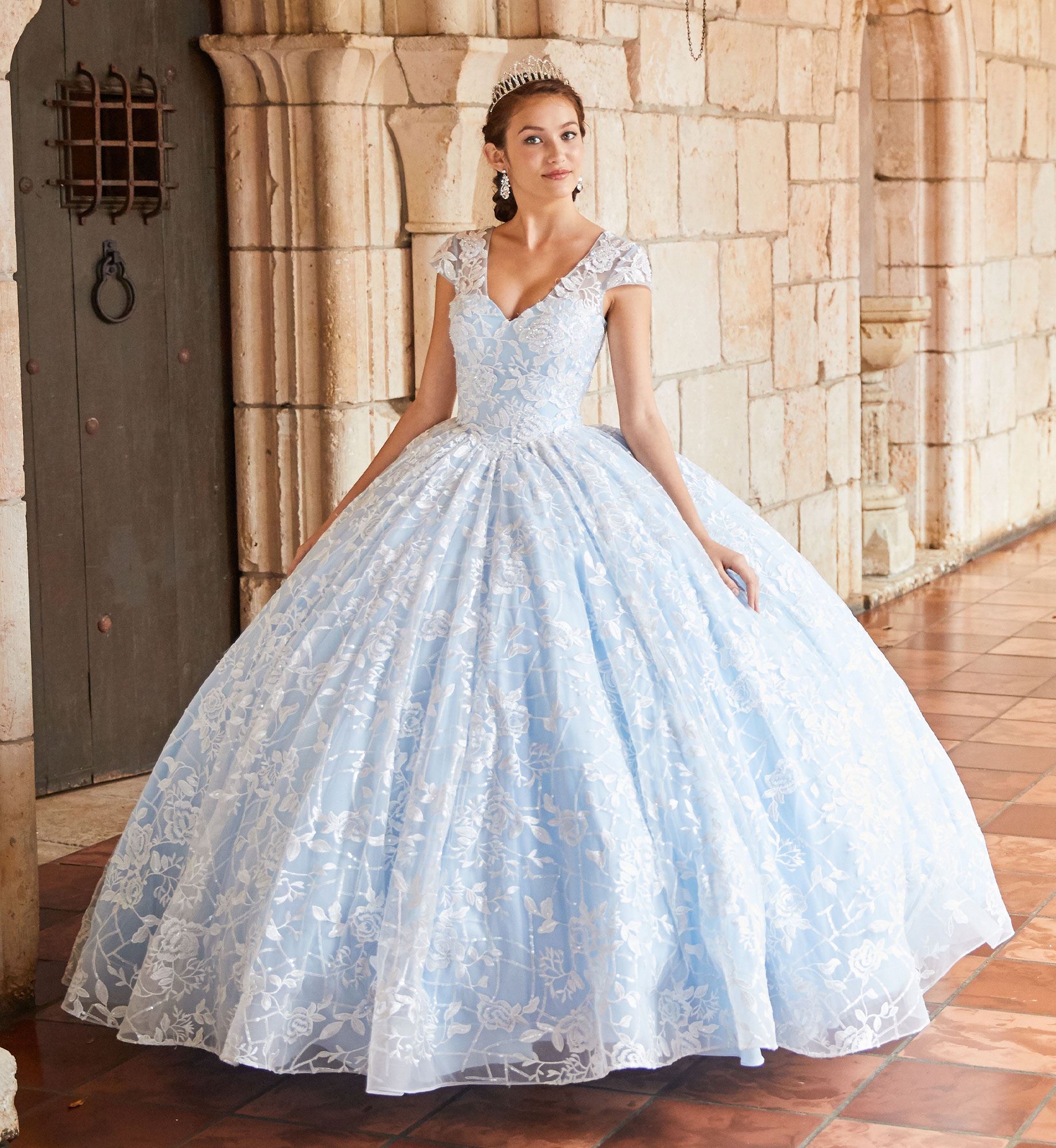 Brunette model in blue lace quinceañera dress